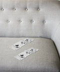Two interlocking hook plates for Solid As A Rock 10 Piece Heavy Duty Iron Sofa Connector Screws on gray sofa.