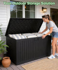 Heavy Duty 270 Gallon Outdoor Storage Box With Solid Locking Lid, Built Like A Tank For Rain Or Shine, Resin Deck Crate For Patios Yards And Pools, Keeps Cushions Locked Down Tight In Black, shown in use with cushions.