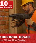 Rotary hammer drill with masonry bit drilling into a brick wall, worker wearing hard hat and safety vest.