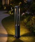 Modern Black LED Pathway Lights Sleek Cone Bollards Heavy Duty Aluminum Housing IP65 Waterproof Outdoor Walkway Lamps on grass with warm glow.