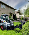 Beefy Skid Steer Tree Pruner Attachment With 42 Inch Brush Cutter on grass in residential garden setting