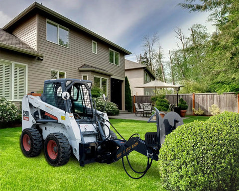 Beefy Skid Steer Tree Pruner Attachment With 42 Inch Brush Cutter on grass in residential garden setting