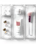 Clear 4 Piece Modular Drawer Bin Set For Bathroom And Vanity Organization with makeup items inside