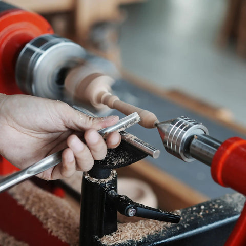 NCK Series Quick Change Woodturning Lathe Jaws For Pipe And Spoon Making in action, hand using chisel on rotating wood