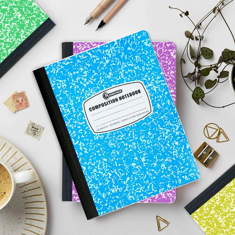 100 Pack Wide Ruled Composition Notebooks With Hard Covers, 200 Pages Each in assorted marble colors, on desk with stationery
