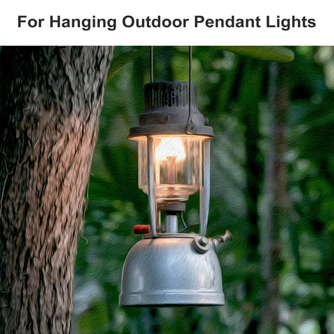 Old-fashioned metal lantern hung on a tree branch outdoors, glowing warmly in the evening, ideal for garden or patio use.