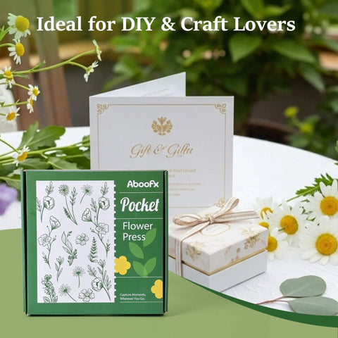 Mini Flower Press Kit For Small Blooms And Leaves, packaging and contents shown on a table with flowers and a gift box.