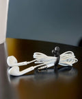 Earbuds wrapped neatly with Gear Tie Reusable Rubber Twist Ties 8 Pack Assorted Colors For Wires And Cables DIY Projects And Home Organization Made In The USA Flexible Grip Ties With Bendable Wire