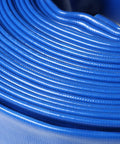 Close-up of Heavy Duty Flat Lay Hose 6 Inch Diameter 300 Feet Long Sump Pump Discharge Backwash PVC Line rolled up.