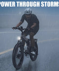Cyclist riding Badass 9000W Dual Motor Fat Tire Ebike For Adults in rain, showcasing 26x4 fat tires on wet road