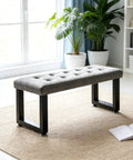 Heavy Duty Steel Table Legs 16 Inch Rock Solid Metal Bench Legs Set Of Two supporting a tufted gray bench in a modern living room.