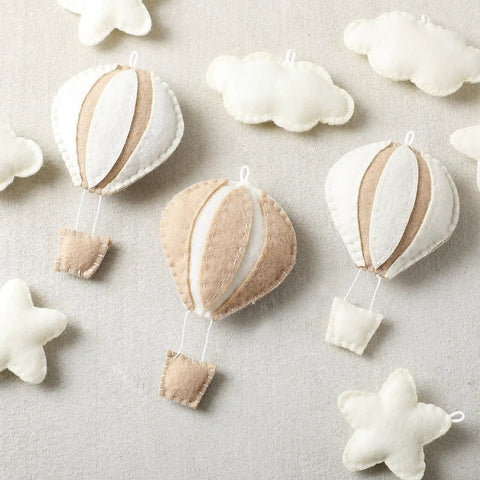 10 Piece Star Hot Air Balloon And Cloud Nursery Decor Set with khaki felt balloons, clouds, stars for kids' bedroom wall art.