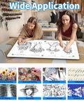 Two women using an A2 Magnetic LED Light Pad for Diamond Painting, Tracing and Sketching, Large 25.2 by 18.4 Inch Light Box.