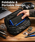 Hand placing Pro 140-In-1 Computer Repair Kit with magnetic bits into a compact black carrying pouch next to tools on a desk.