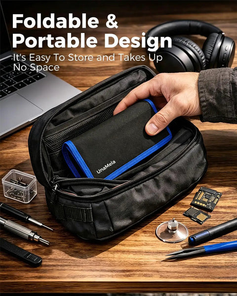 Hand placing Pro 140-In-1 Computer Repair Kit with magnetic bits into a compact black carrying pouch next to tools on a desk.