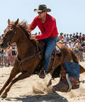 Two Piece Leather Spur Straps For Cowboy Boots in action at rodeo, showing adjustable fit on cowboy's boot