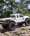 White SCX24 Base Camp 4x4 Rock Crawler Ready To Run RC Truck Brushed with Spektrum radio on rocky terrain
