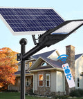 Beast Mode Bright 1000W LED Solar Street Light With Remote Control in front of a house, showcasing dusk to dawn feature.