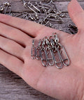Hand holding 30 Pack Fishing Speed Clips Quick Change Snap Swivels With Ball Bearing Swivels for freshwater and saltwater use