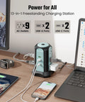 Power Strip Tower Surge Protector With 9 Outlets And 4 USB Ports, 10 Ft Extension Cord, shown on a desk charging multiple devices.