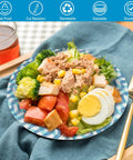Sturdy 8.5 Inch Disposable Paper Plates 150 Count For Holidays Parties Picnics And Everyday Meals Heavy Duty Dinnerware Built For Mess Free No Fuss Cleanup And Easy Everyday Use with salad on blue-patterned plate on table