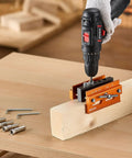 Knockout Self Centering Dowel Drill Jig Kit For Woodworking With Adjustable Width Clamps and Precision Guide Bushings Crafted From Heavy Duty Aluminum in use on wood.