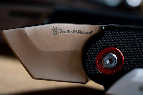 Close-up of Compact 2.5 Inch Folding Keychain Knife With 1.75 Inch Modified Tanto Blade And G10 Handle, showing blade edge and screw detail
