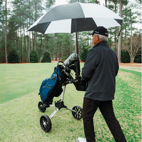 Universal Umbrella Holder Clamp for round or oval tubing fits golf carts, keeping umbrella steady on a golf course under trees.