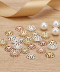 Assorted gold, silver, and rose gold hollow flower charms from Natural Metal Bead Caps And Flower Spacer Pendants For DIY Jewelry Making.