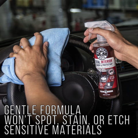 Hands cleaning car interior with All In One Interior Cleaner And Protectant With Black Cherry Scent, 16 Oz, Safe On Leather, Vinyl, Plastic, Rubber And Glass, Cleans, Protects, And Refreshes Dash, Doors, And Panels For A Factory Clean Look And Fresh Car Vibe.