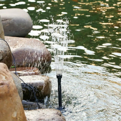 LED Fountain Pump With Lights Submersible Water Pump For Aquarium Pond Garden Backyard 10W 160GPH 600L/H installed near rocks