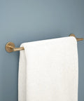 Trinsic 18 Inch Towel Bar in Champagne Bronze for your bath upgrade with towel hanging on rugged zinc die cast bar