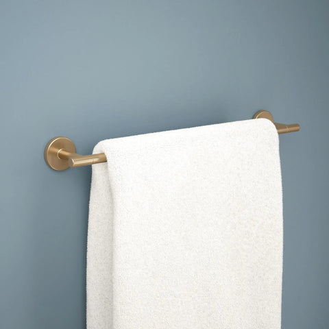 Trinsic 18 Inch Towel Bar in Champagne Bronze for your bath upgrade with towel hanging on rugged zinc die cast bar