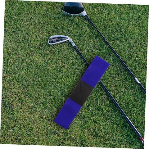 Golf Swing Analyzer Arm Training Aid And Corrector Dual Use For Practice Or Home Sessions on grass with golf clubs.