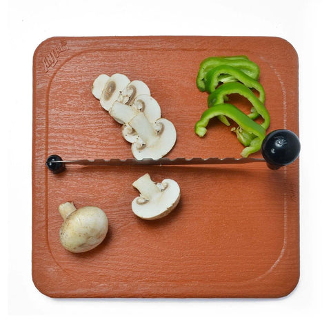 Anjali Fantastique Deluxe stainless steel vegetable cutter on wooden board; serrated blade, black knob.