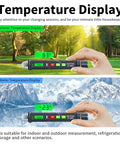 Digital thermometer displaying summer 83°F and winter -23°F temperatures in outdoor settings with hand holding device.