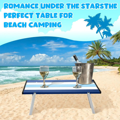 Foldable Beach Table For Picnics And Camping, Navy Striped, Aluminum, 16x11x5 in, with wine glasses and cooler on a sandy beach.