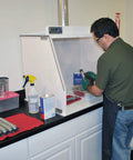Person using Heavy-Duty 40-Inch Wide Ducted Fume Hood With 6-Inch Exhaust Collar and LED Lighting in lab setting