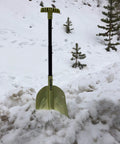 Grab And Go Collapsible Snow Shovel For Camping And Car Emergency Kit standing in snow with adjustable handle and multi angle blade.