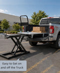 Electric Hydraulic Lift Table Cart Featuring Plug And Play One Touch Operation With Slick Retractable Scissor Frame For Smooth Cargo Hauling Heavy Duty Mobile Dolly That Folds Flat positioned at a truck bed.