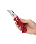 Hand holding Retractable Utility Knife Set With Heavy Duty Razor Blade And 3 Extra Blades Refills, Built For Cardboard, Packages, Warehouse, Office, And Construction Jobs, Ergonomic Red Cutter For Quick, Clean Cuts, A Real Workhorse.
