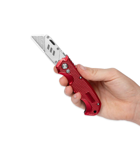 Hand holding Retractable Utility Knife Set With Heavy Duty Razor Blade And 3 Extra Blades Refills, Built For Cardboard, Packages, Warehouse, Office, And Construction Jobs, Ergonomic Red Cutter For Quick, Clean Cuts, A Real Workhorse.