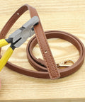 2mm Small Hole Punch Pliers For Watch Bands And Leatherwork 5.5 Inch Round Metal Hole Puncher in action on brown leather strap