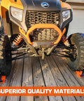 Front view of ATV secured with Beefy Heavy Duty Wheel Chock and Tie Down Kit with 4400lb break strength trailer tire straps on wooden deck.