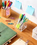 Slick 10 Pack Colorful Metal Chip Bag Clips With Rubber Finger Guards And Heavy Spring Steel Design on a desk with stationery.