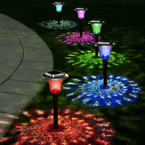 Solar Outdoor Path Lights 6 Pack With Lit Color Changing And Static Warm Glow Modes along a garden pathway at night