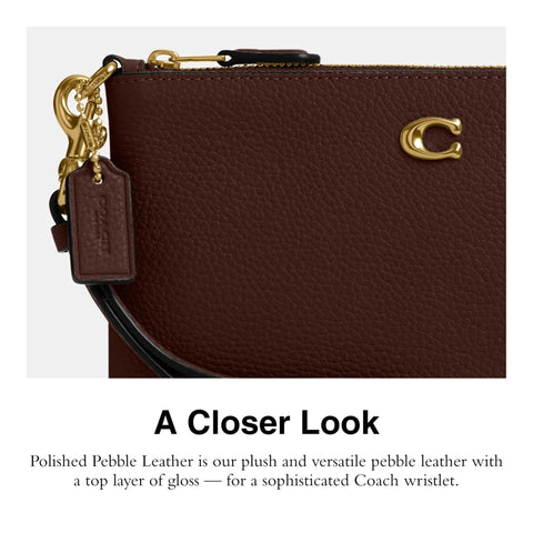 Close-up of Top Shelf Small Wristlet Crafted From Smooth Pebble Leather With Signature Hardware showcasing the glossy finish.