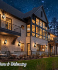 Heavy Hitter 16 Inch Large Outdoor Wall Light Fixtures Built Tough Exterior Metal Lantern Sconces illuminating a home exterior at night.