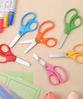 Colorful 36 Pack Kid Scissors For School And Home, 5 Inch Safety Blunt Tip Scissors With Comfort Grip on a crafting table