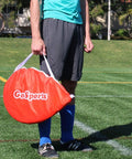 Person holding carrying case with Portable Pop Up Soccer Goals For Backyard Set Of Two 4 Foot Nets With Agility Training Cones And Carrying Case Easy Setup So You Can Play Anywhere Outdoors For Kids And Adults